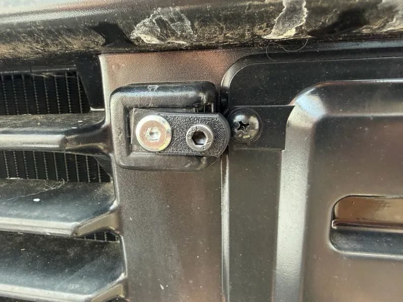 License plate adapter bolted to the factory Japanese plate mount on the front of a kei truck